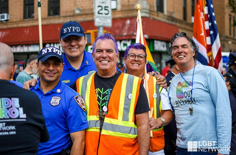 A group of 6 people smiles for the camera.