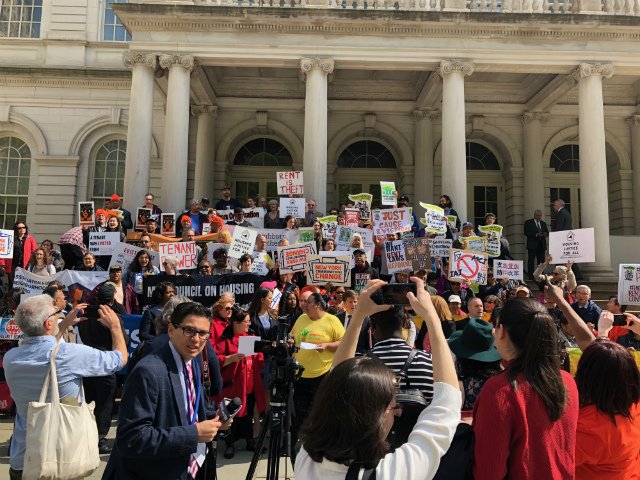 Tenants and state representatives gather outside City Hall before they testified at a state hearing on rent reform laws in Lower Manhattan on Thursday.