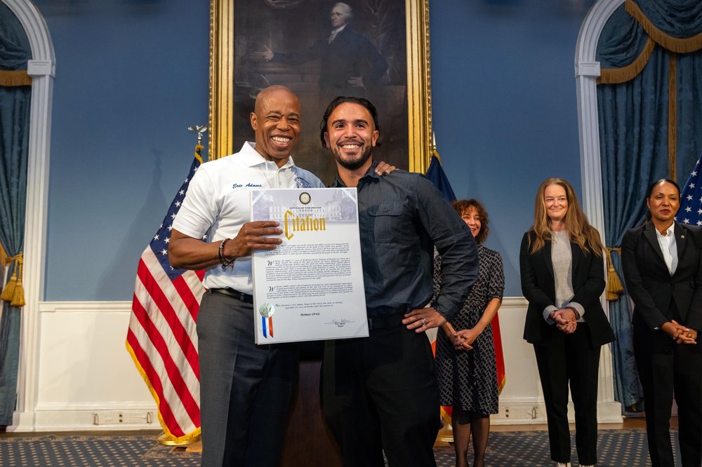Mayor Eric Adams thanks lifeguard Romeo Ortiz, who joined four other lifeguards, emergency medical technicians and New York City Police Department officers in the heroic rescue of a New Yorker from a shark attack on Rockaway Beach on Aug. 7, 2023.