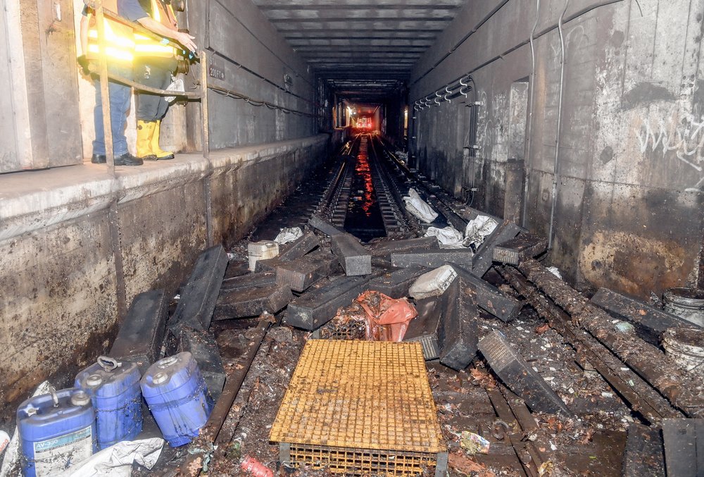 Subway tracks filled with rubble.