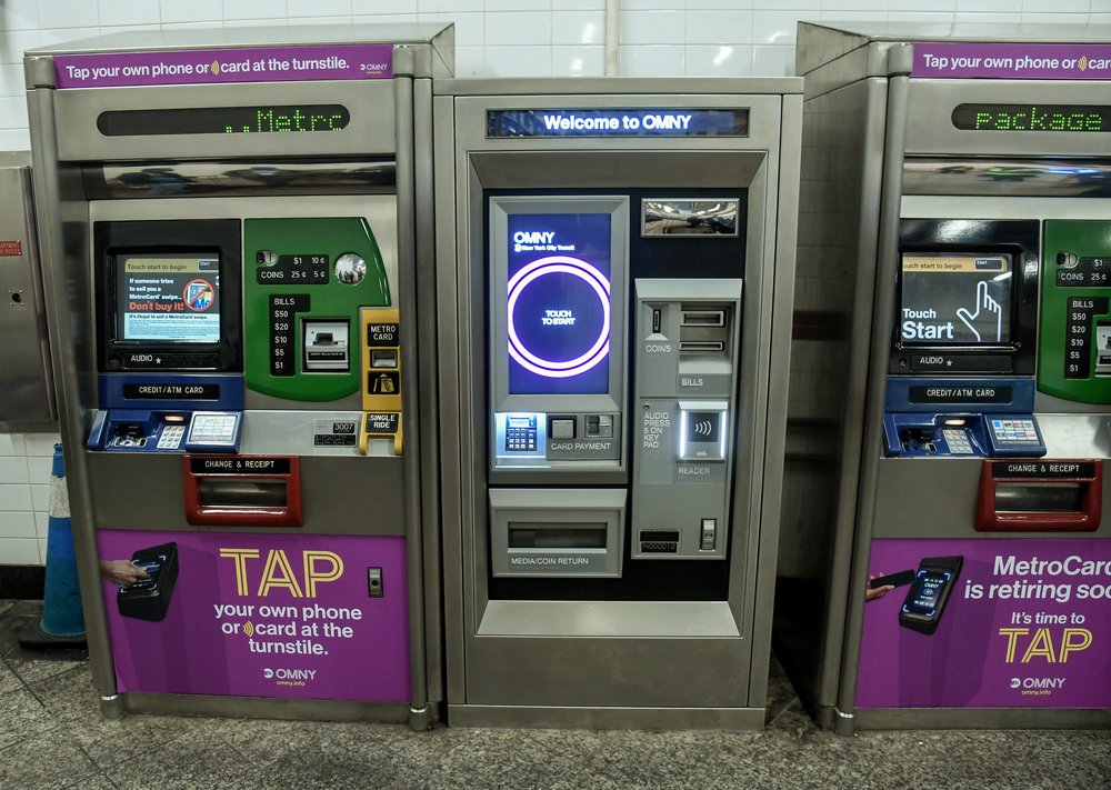 A row of vending machines in a subway station.
