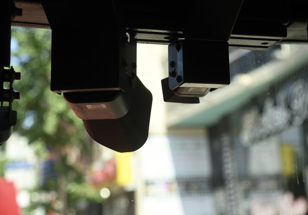 Cameras mounted to the windshield of an MTA bus.