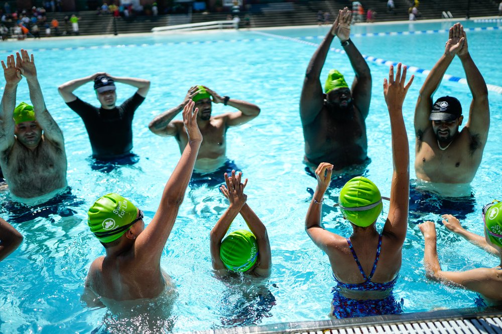 People practicing swimming in a pool.