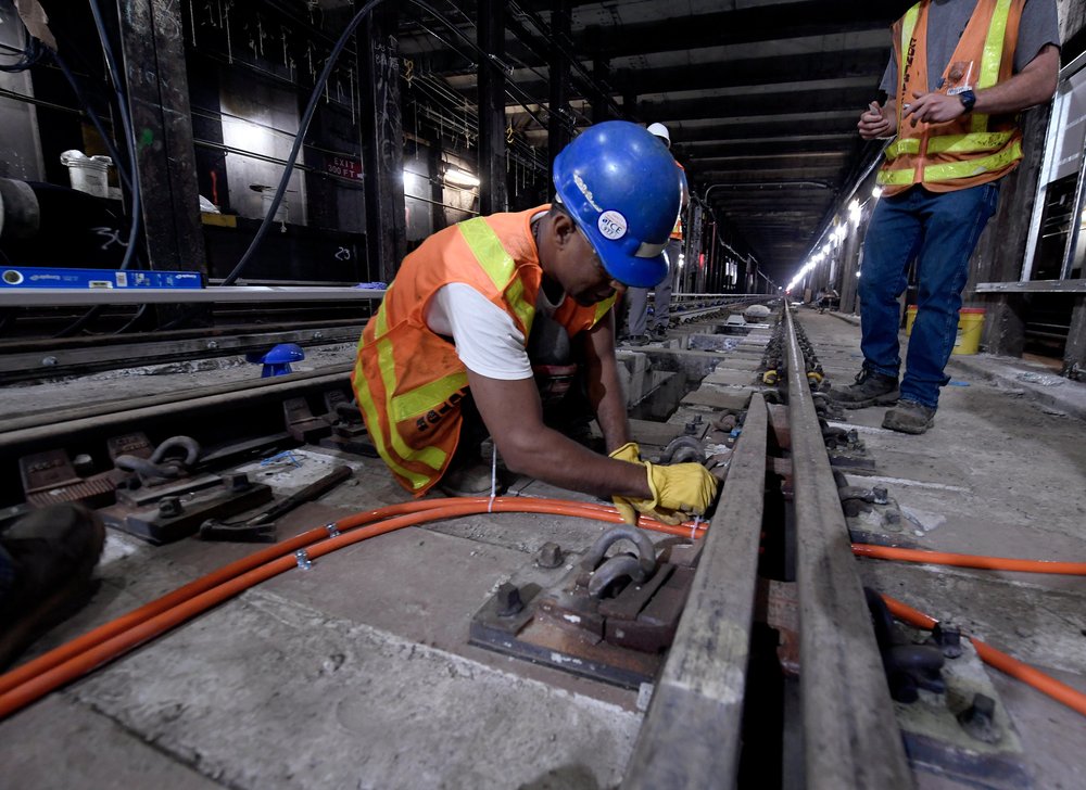 A worker fixes tracks in a G train tunnel near the Court Square station on Aug. 6, 2024.