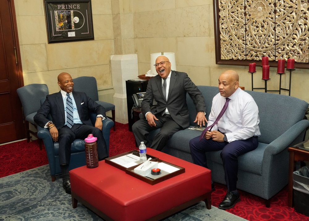 New York City Mayor Eric Adams in a room with Carl Heastie and one other man in Albany