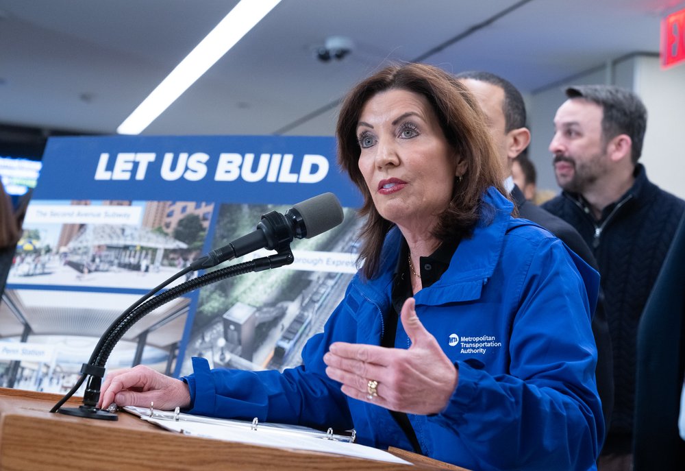 Gov. Kathy Hochul before a sign that says let us build