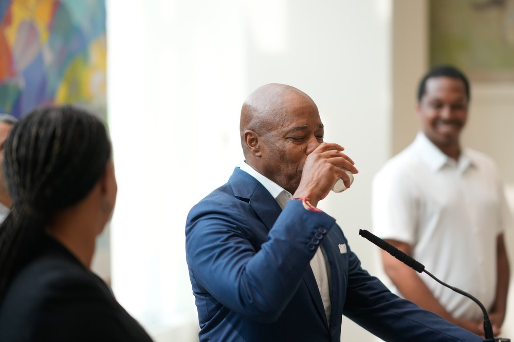 Mayor Adams drinks a glass of water.