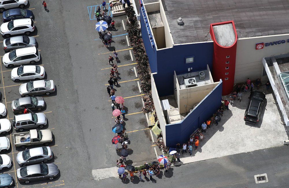 578229417gettyimages-853694194-jpg.jpeg People wait in line at a bank as they deal with the aftermath of Hurricane Maria on September 25, 2017 in San Juan Puerto Rico. (Photo by Joe Raedle/Getty Images)