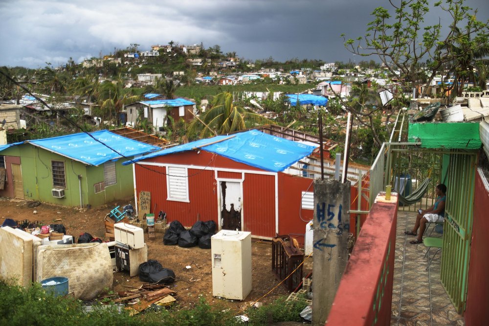 Uncollected debris stand near damaged homes in an area without electricity on October 15, 2017 in San Isidro, Puerto Rico. <br/>