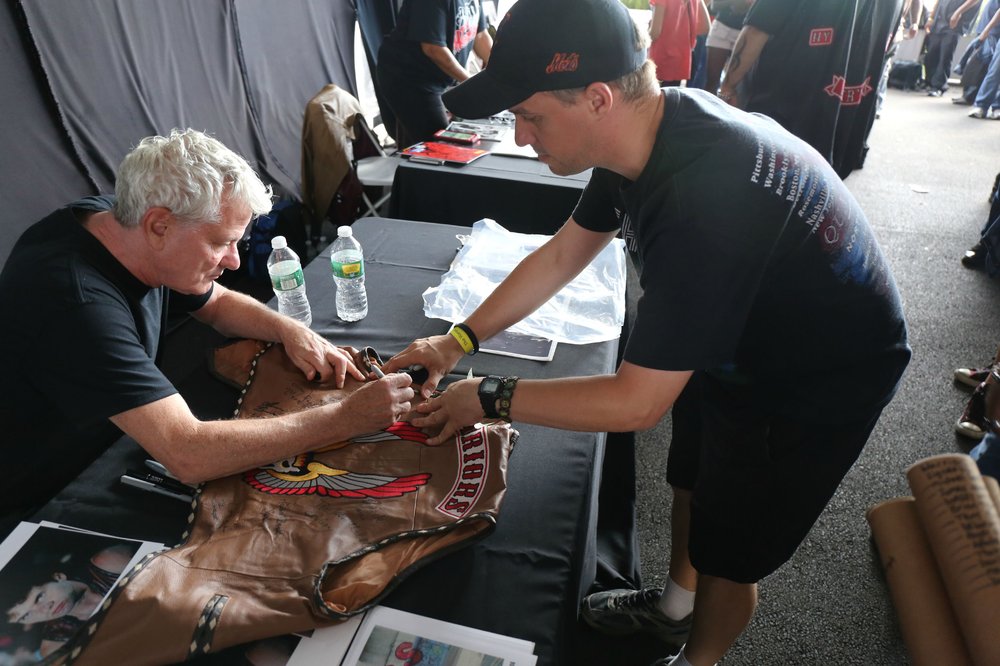 Thomas G. Waites signs a vest<br/>