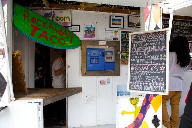 5rockawaytaco14.jpg ROCKAWAY TACOIf, like many of us, it's against your bloody principles to wait on interminable lines for food in a city with myriad options, the formidable queue for Rockaway Taco may be cause for alarm. It shouldn't be. Look at it this way: you've had a long, salty day at the beach, you're mysteriously fatigued from... doing nothing beyond napping and Frisbee, and a little burned and buzzed on top of that, and you have little energy left to do anything besides stagger around like a zombie dragging a beach bag. Zoning out and standing on line under these circumstances isn't the worst thing in the world! Buy a bottle of water or something from the deli and wait it outâRockaway Taco's kitchen is a well-oiled machine, and even if the line stretches to the corner, you'll be devouring succulent fried fish tacos in 30 minutes or less. (Halfway through the line and you can sate yourself with an Italian ice from DiCosmo's.) This place never fails to hit the spot, and your subway ride home will be greatly enhanced with a full belly. (It's not on the boardwalk and thus much closer to the train.) Or swing by in the morning on your way to the beach when it's less of a scene, that works too. But don't miss it. (John Del Signore)95-19 Rockaway Beach Blvd // Website