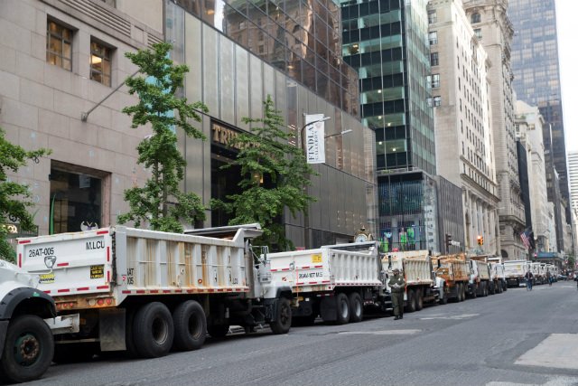 Sanitation department trucks line Fifth Avenue outside Trump Tower, in New York on May 16, 2019