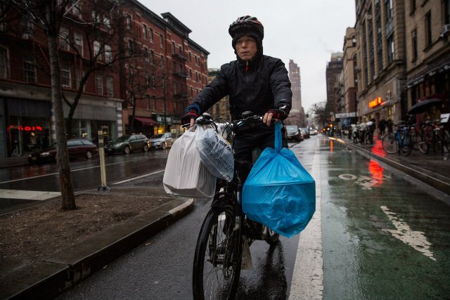 Delivery cyclist Dong Shixiang, delivering food on his e-bike last year