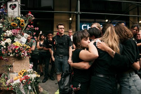 Mourners gather at the spot where 20-year-old Robyn Hightman was killed by a truck driver on Monday morning