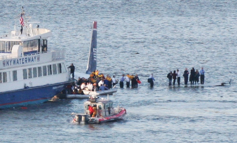 63bde7067shutterstock_9515468a-jpg.jpeg Passengers boarding a ferry after leaving the plane (Bebeto Matthews/AP/Shutterstock)