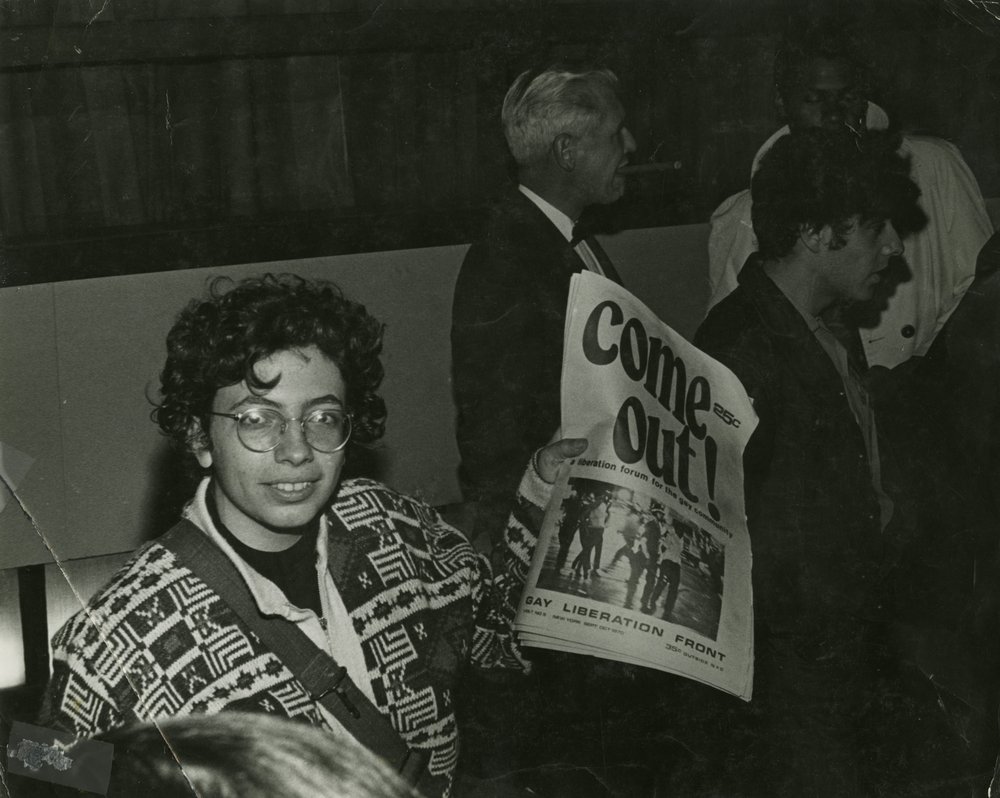 Martha Shelley sells Gay Liberation Front paper during Weinstein Hall demonstration, 1970. Photo by Diana Davies.<br/>
