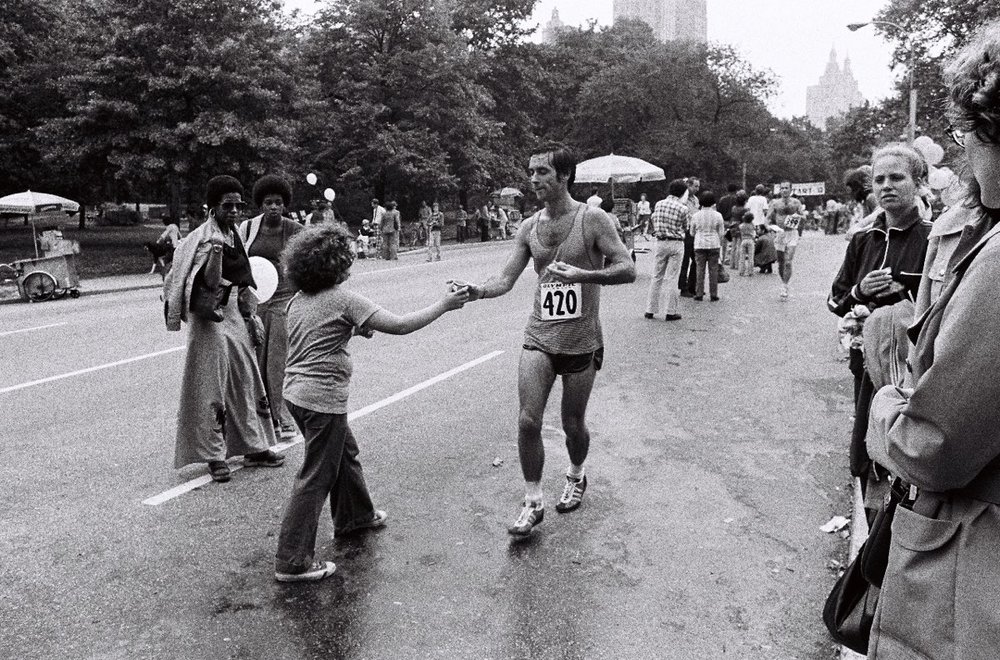 Mary Engel, daughter of marathon photographer Ruth Orkin, hands water to a runner at the 1974 race. (Ruth Orkin/<a href="http://www.orkinphoto.com/">Ruth Orkin Photo Archive</a>)