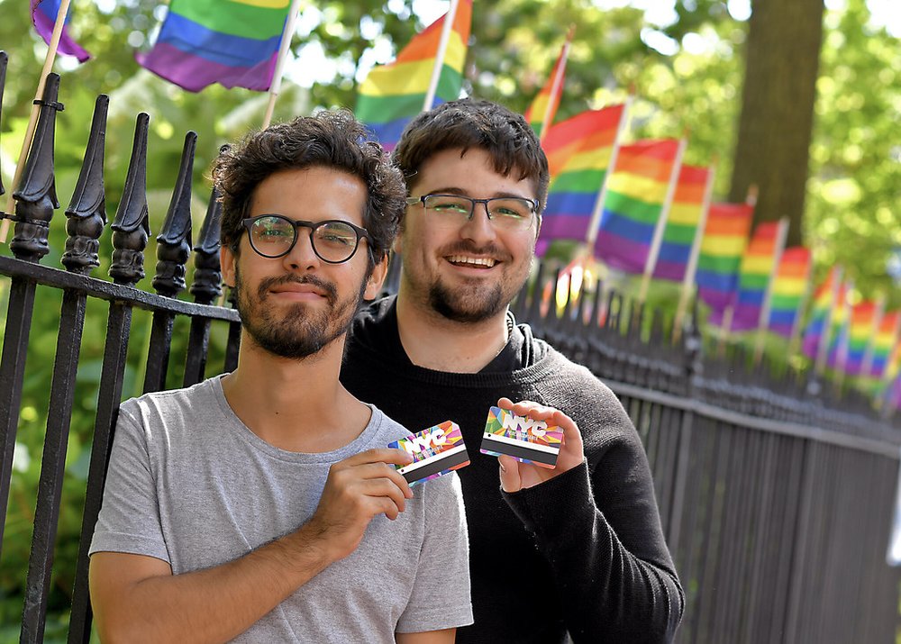 People holding the MTA's WorldPride MetroCard (MTA Photos)