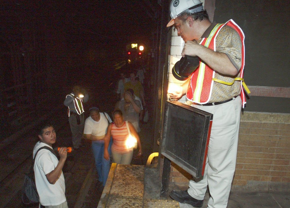 MTA workers help subway passengers from trackers (Diane Bondareff/AP/Shutterstock)