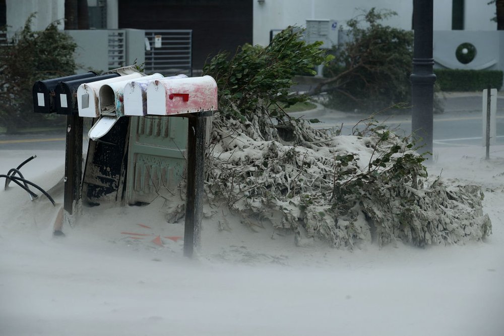 6ea13fcd8gettyimages-845409390-jpg.jpeg Blown sand from Pompano Beach coats bushes and mail boxes as Hurricane Irma hits the southern part of the state September 10, 2017 in Pompano Beach, Florida. (Getty)