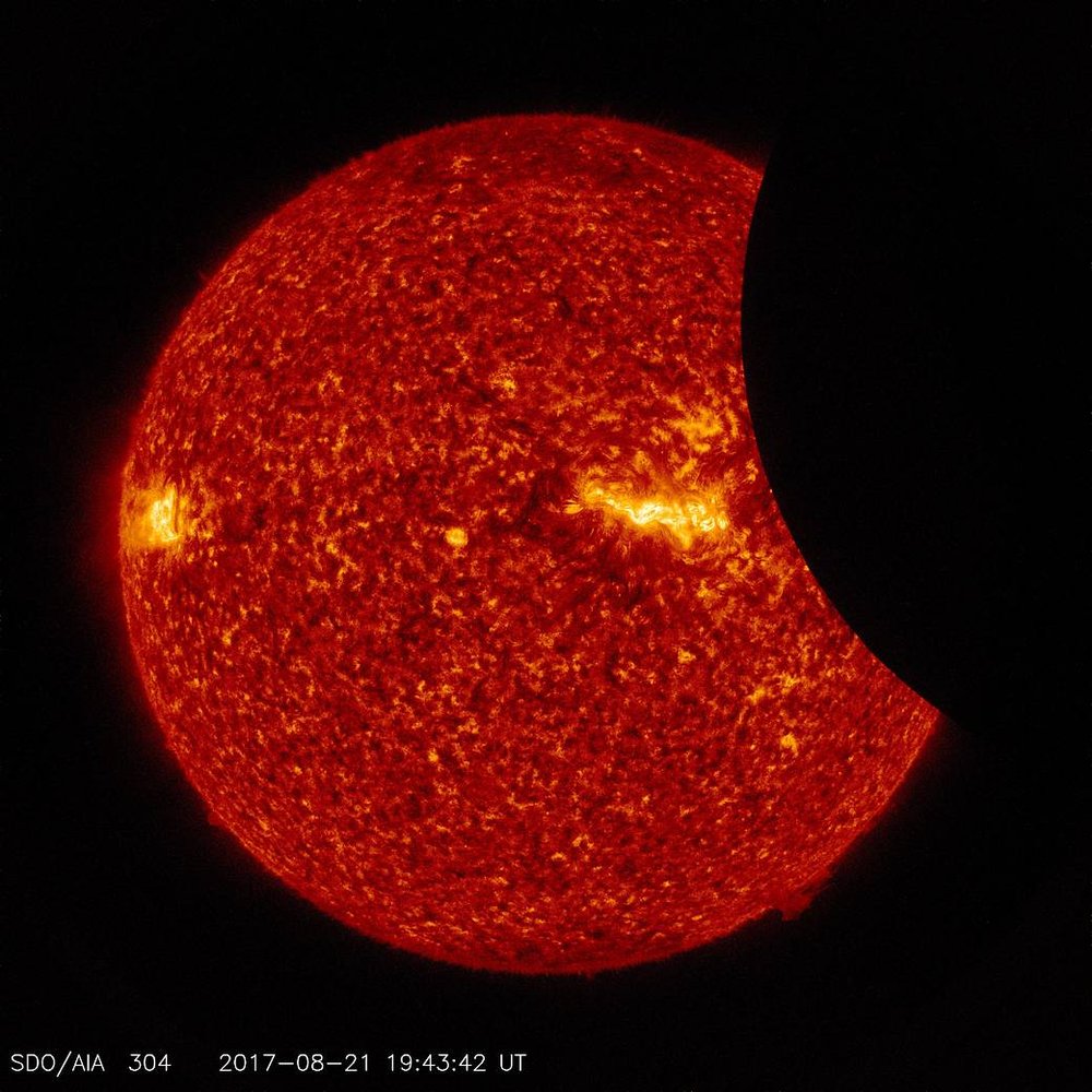 6ea20315b082217moon2-jpg.jpeg Image of the Moon transiting across the Sun, taken by SDO in 304 angstrom extreme ultraviolet light