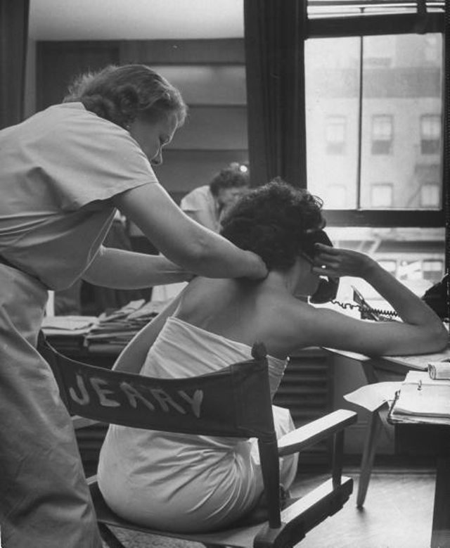 6fordmodelingflashback0211.jpg "On the telephone, Eileen Ford getting a massage to relieve tension felt from holding telephone in shoulder position."