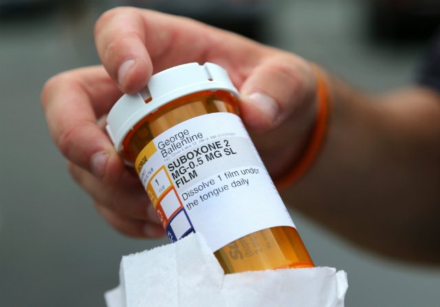 Newly-released inmate George Ballentine holds his prescription medicine Suboxone outside a pharmacy in Greenfield, Massachusetts