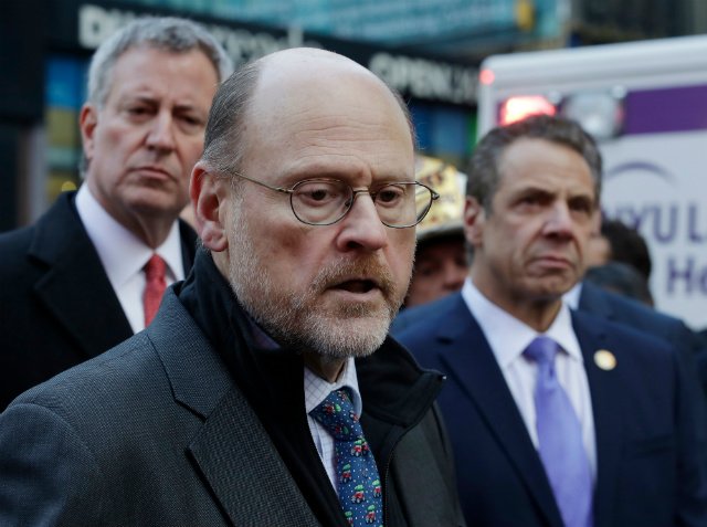 MTA Chairman Joe Lhota, center, talks at a news conference with New York Mayor Bill de Blasio, left, and Governor Andrew Cuomo, outside the Port Authority Bus Terminal in New York.