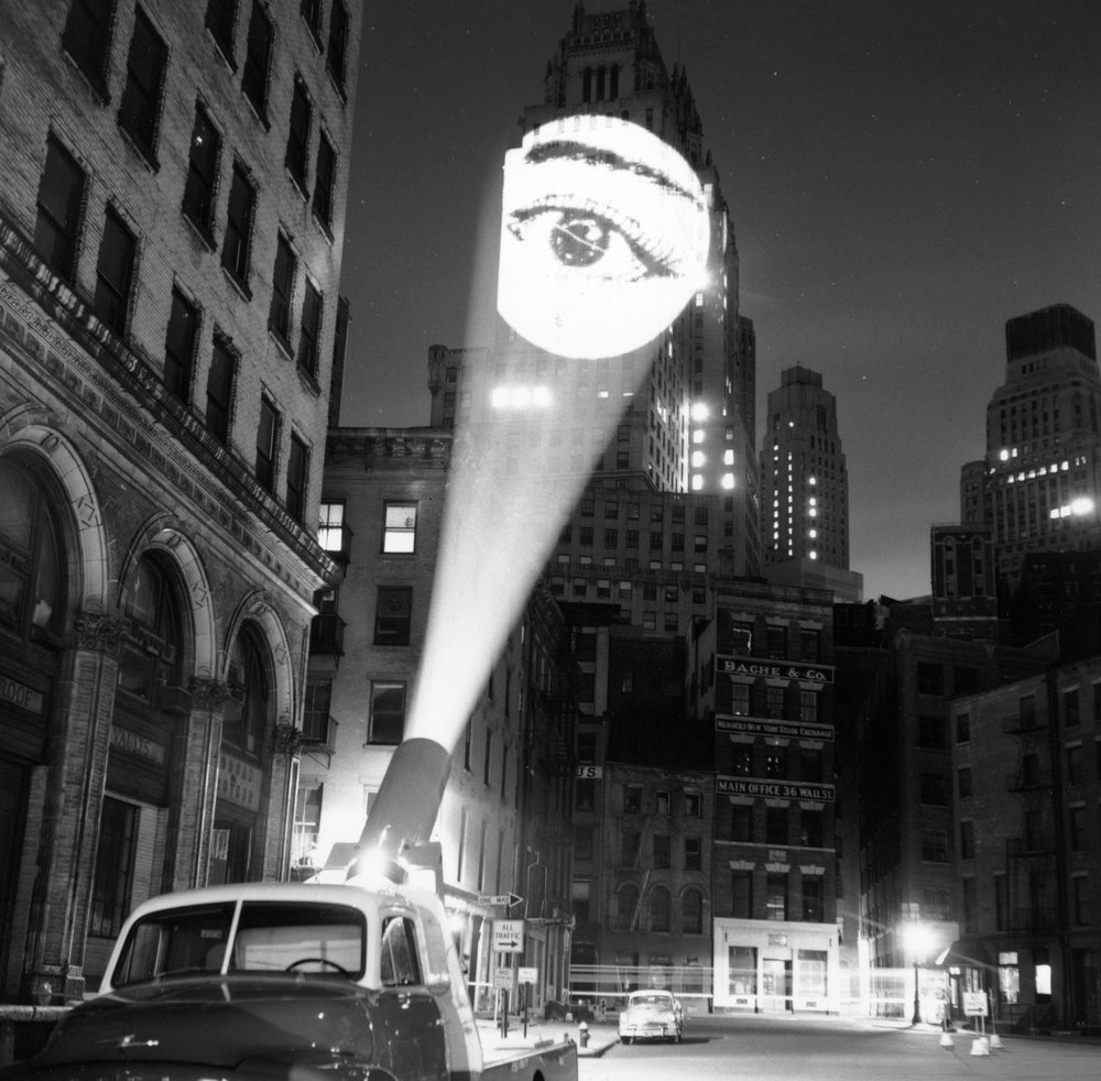 76c45345e.jpeg "An image of an eye is projected onto a building at New York by a skyjector. February 1960."