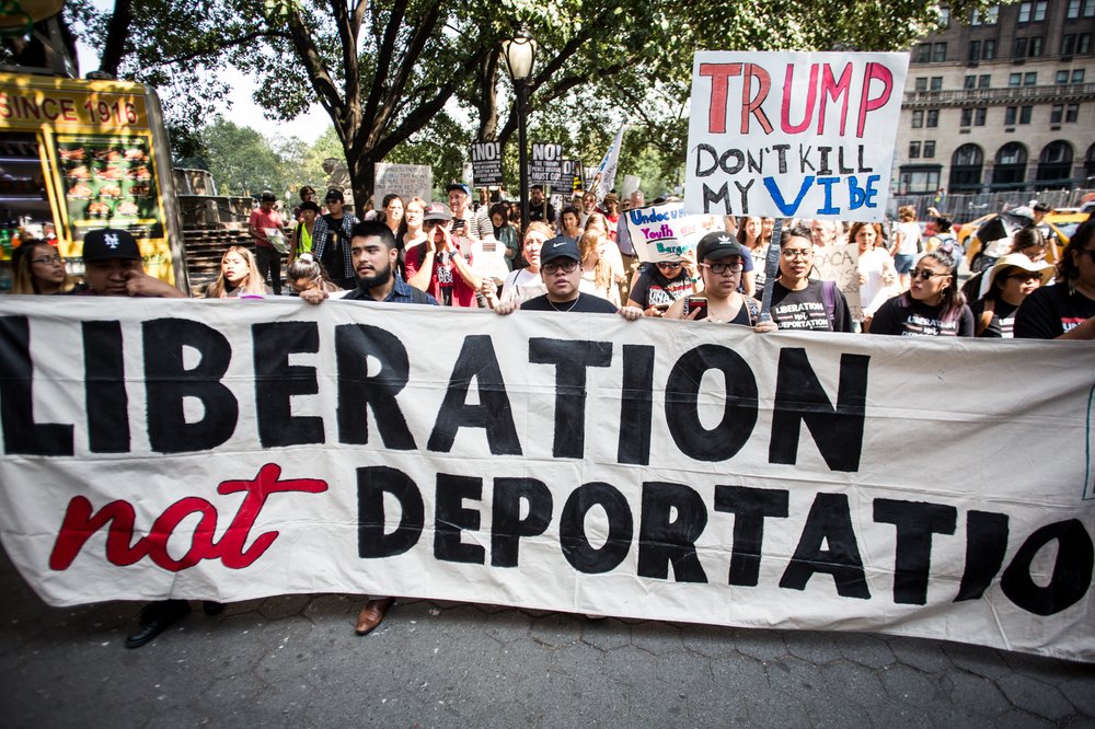 77905cd1b090517dacatrumptower-2-jpg.jpeg Protesters hold a large banner reading "LIBERATION NOT DEPORTATION" at a demonstration in NYC against the Trump administration's attempt to end DACA.