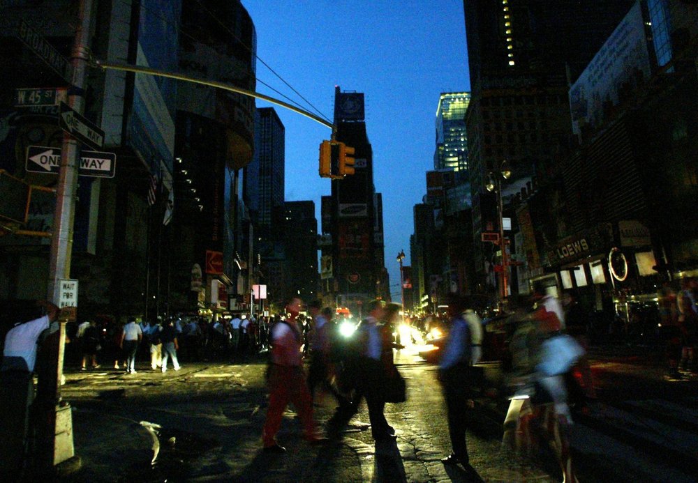 Pedestrians walk through Times Square on August 14, 2003 (Jason Szenes / EPA/Shutterstock)