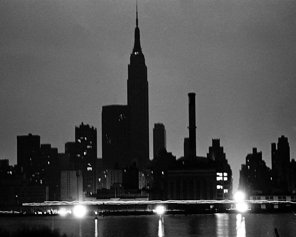 NYC skyline from Queens during the power blackout. Lights glow in a midtown Waterside Con Ed plant as traffic passes on East Side Drive. (Courtesy of Dan Farrell/NY Daily News)