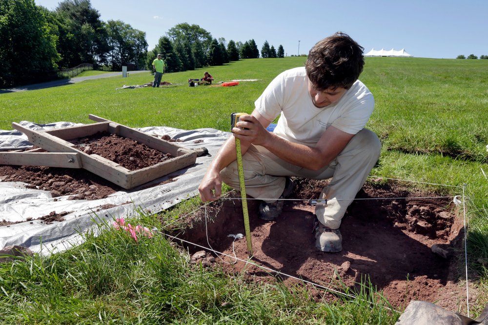7d76e0636shutterstock_9723255h-jpg.jpeg Paul Brown, of the Public Archaeology Facility at Binghamton University, measures a dig at the site of the original Woodstock Music and Art Fair, in Bethel, N.Y. The main mission of Binghamton University's Public Archaeology Facility is to help map out more exactly where The Who, Creedence Clearwater Revival, Janis Joplin and Joe Cocker wowed the crowds 49 years ago (Richard Drew/AP/REX/Shutterstock)