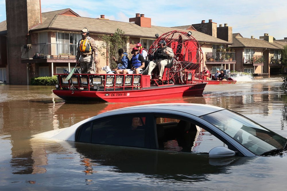 Rescue workers and volunteers help to rescue residents of an apartment complex after it was inundated with water following Hurricane Harvey on August 30, 2017 in Houston, Texas<br>(Getty Images)
