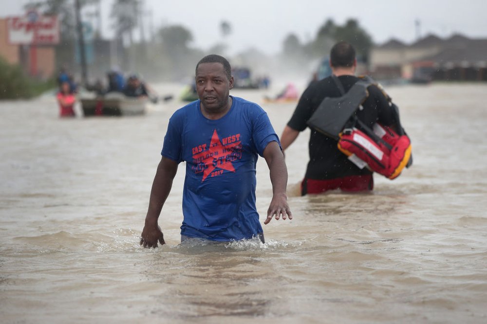 7ed5b9836gettyimages-840308508-jpg.jpeg eople make their way out of a flooded neighborhood after it was inundated with rain water, remnants of Hurricane Harvey, on August 28, 2017 in Houston, Texas.<br>