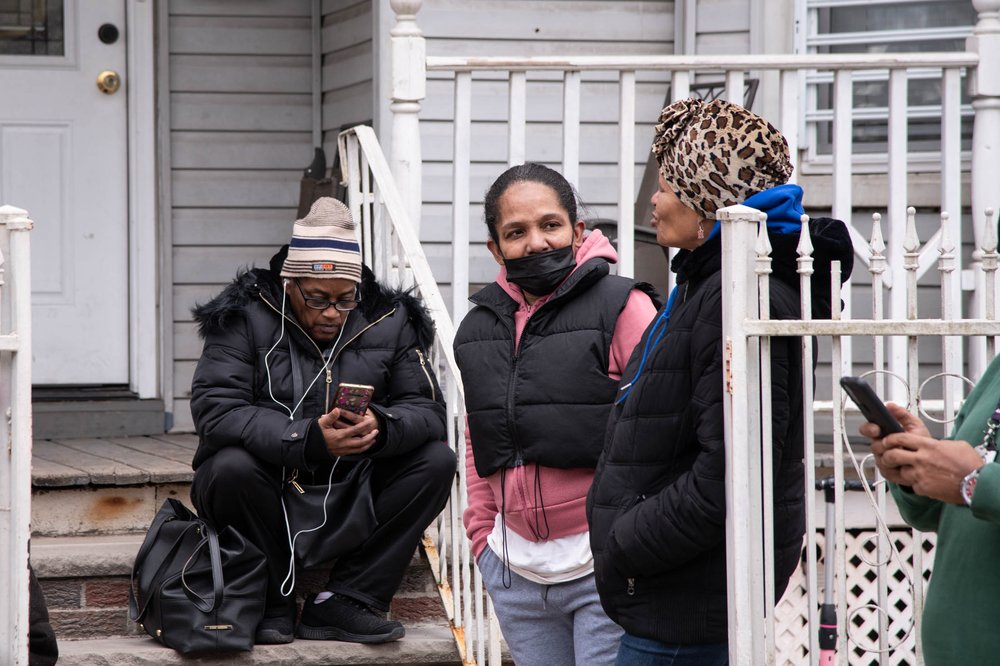 Evelyn Antonetty, hosts her evacuated neighbors on her porch on Newark's 7th Avenue Friday.
