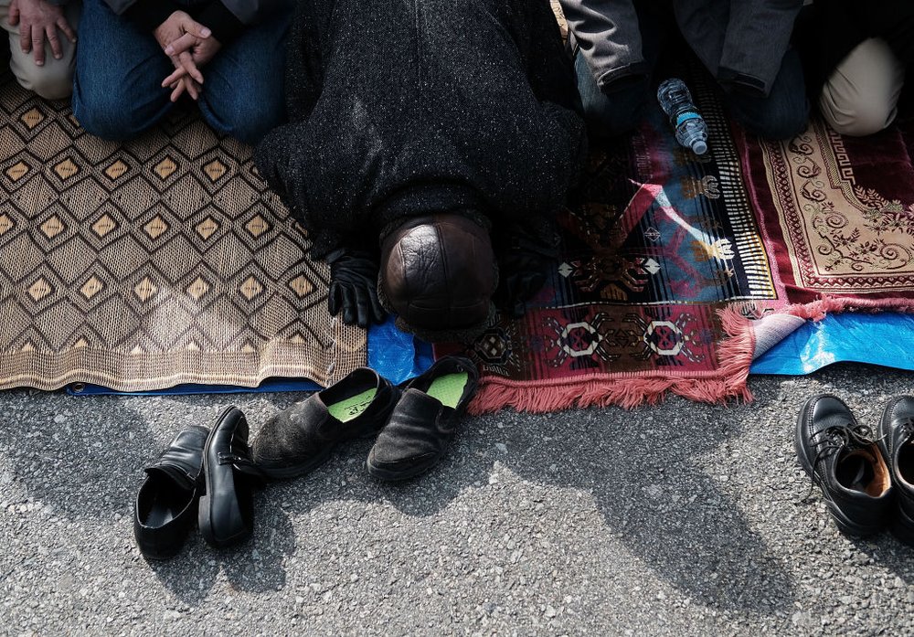 819cb39begettyimages-633701134-jpg.jpeg Muslim men pray at a prayer and demonstration at JFK airport to protest President Donald Trump's immigration ban, February 3, 2017 <br>