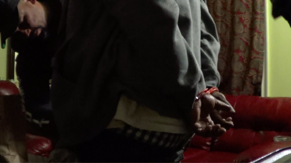 A still from a video obtained by Gothamist/WNYC shows Mount Vernon Police Detective Camilo Antonini taking off a man’s underwear for an anal cavity inspection at an apartment. Police sources say the inspection is in clear violation of departmental rules.