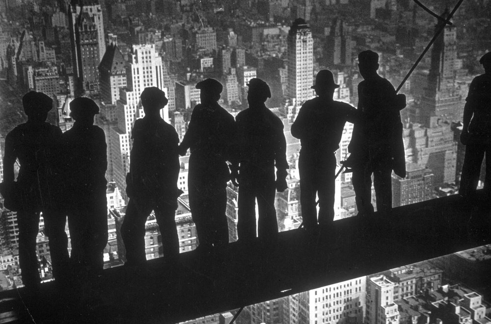 83d9b80a5.jpeg A group of steel workers standing on scaffolding 70 storeys high looking down over New York City from the RCA building, 1938.