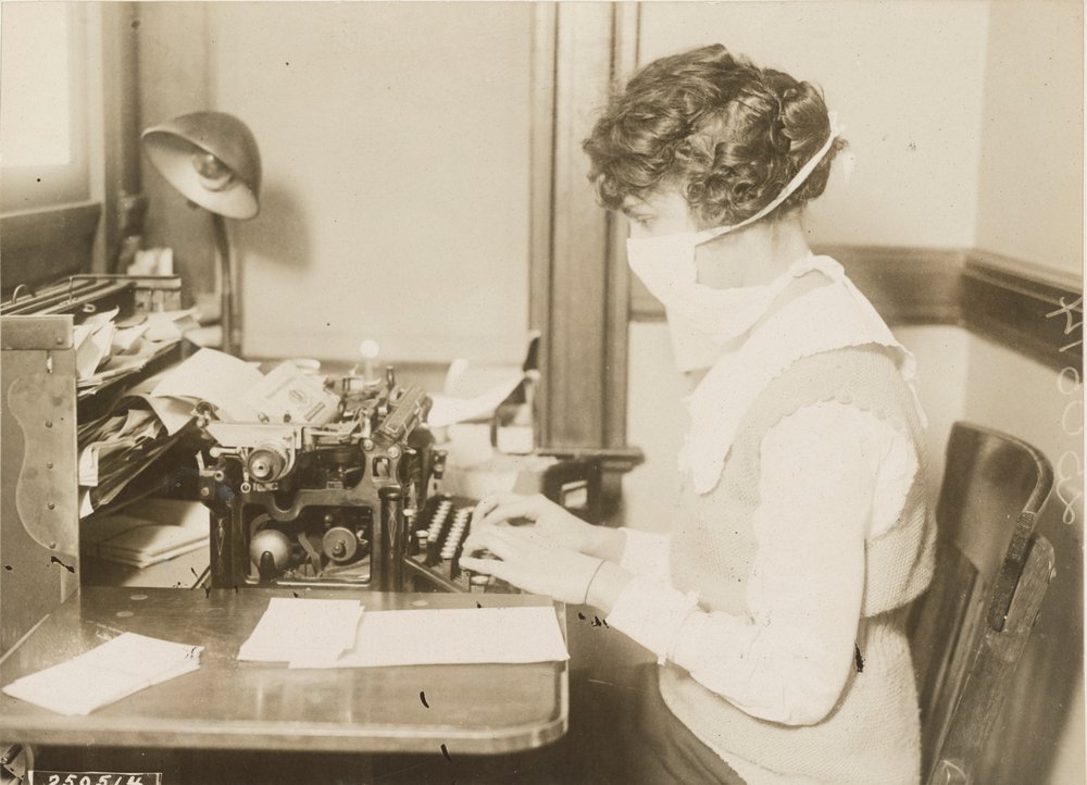 86ead128fgermcity_15-jpg.jpeg Typist wearing mask, New York City, October 16, 1918. (Courtesy of The U.S. National Archives and Records Administration)