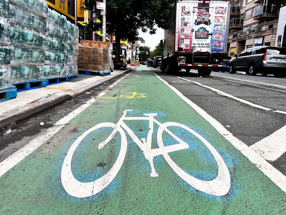 A bicycle logo marking a bike lane painted on Bedford Avenue.