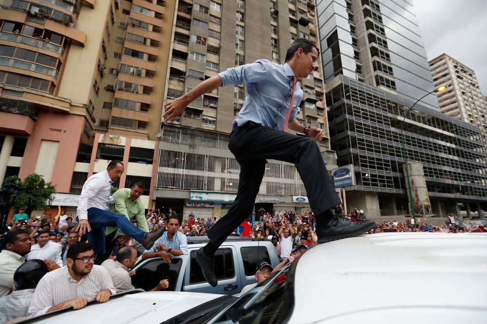 87b44c2bc10152287g-jpg.jpeg National Assembly President Juan Guaido, who declared himself interim president of Venezuela, leaps on to a vehicle to speak to supporters in Caracas, Venezuela. </br>(Eduardo Verdugo/AP/Shutterstock)