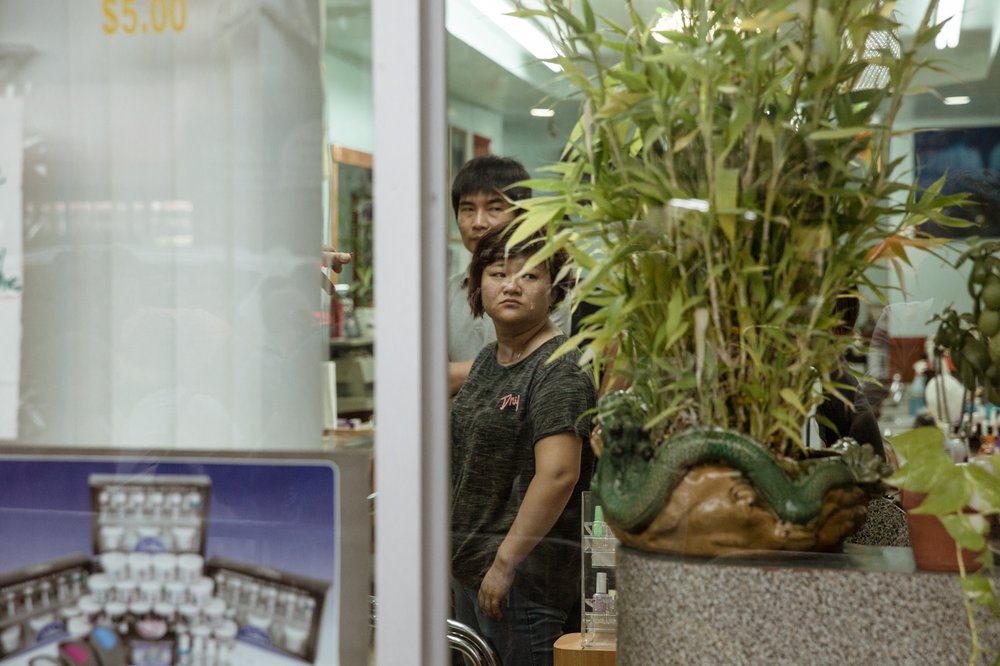 886b732ae20180807gothamist_nailsalonprotest-18-jpg.jpeg Nail salon workers watch the protesters.<br>