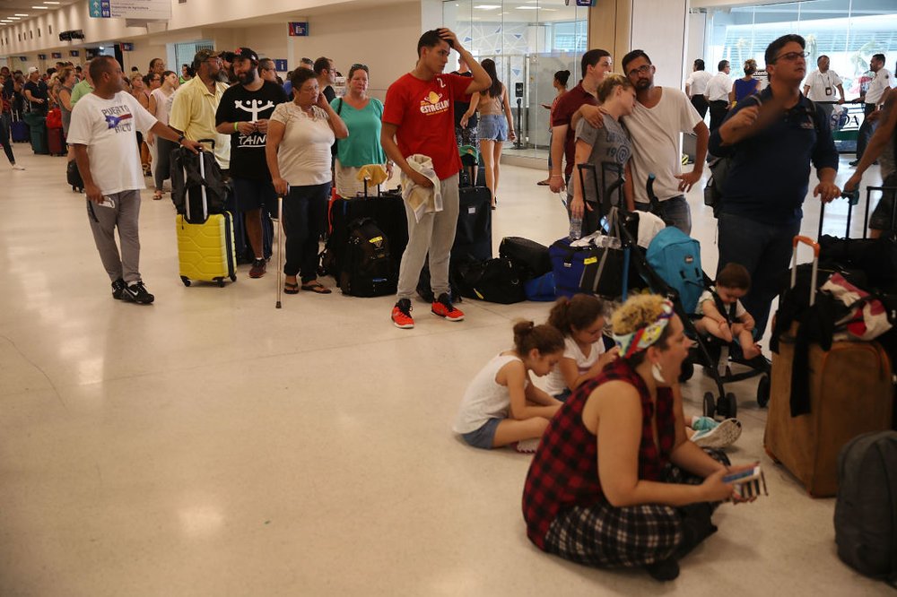 897afeb73gettyimages-853741156-jpg.jpeg People wait in line to get a flight at the Luis Munoz Marin International Airport after Hurricane Maria passed through the island last week on September 25, 2017 in San Juan, Puerto Rico. (Photo by Joe Raedle/Getty Images)