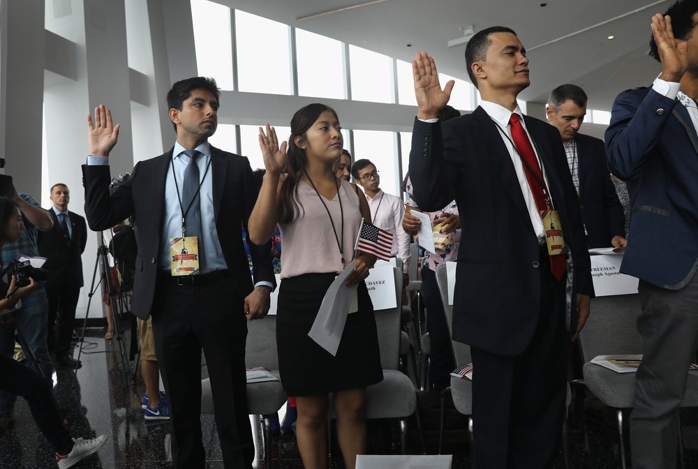 8f6b2aa83gettyimages-831852060-jpg.jpeg Immigrants take the oath of allegiance to the United States at a naturalization ceremony held in the observatory of the One World Trade Center <br>
