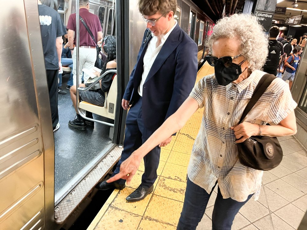 Jacquelyn Goldenberg points to a wide gap between a subway train and the platform.