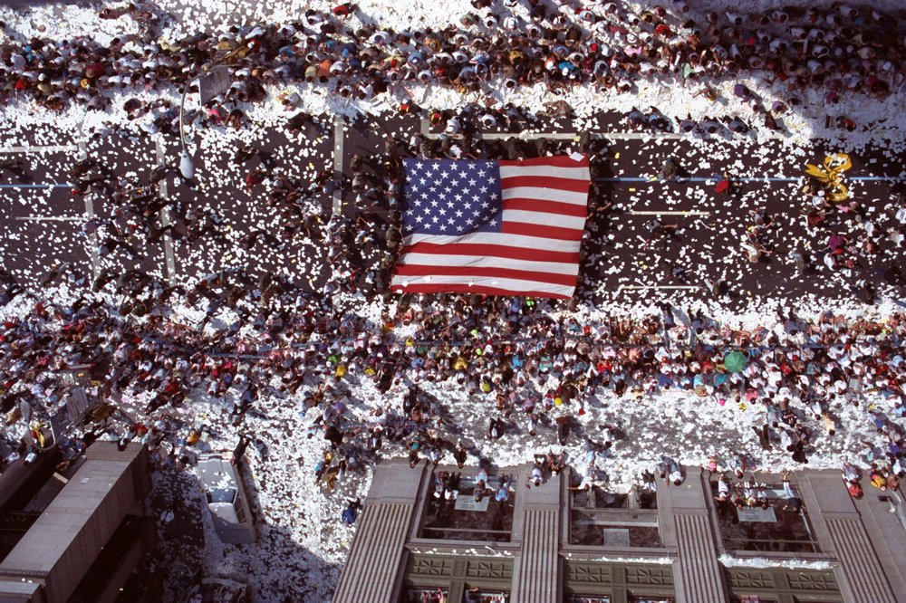 90dac10bfshutterstock_6553890a-jpg.jpeg Marchers carry a giant American flag up Broadway in New York during Operation Welcome Home, the ticker-tape parade for returning veterans of Operation Desert Storm in 1991 (Ron Frehm/AP/Shutterstock)