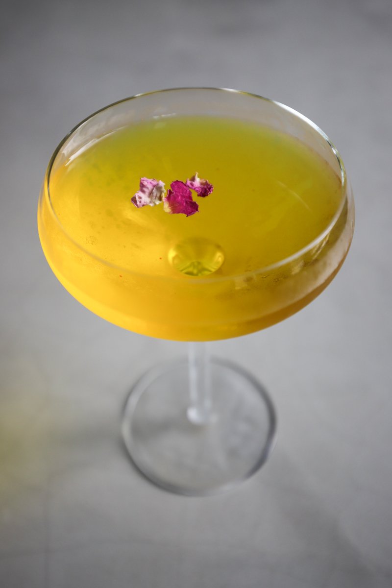 Saffron Vesper: housemade saffron rosewater syrup, lillet, vodka, gin, garnished with dried Iranian rose petals<br/>