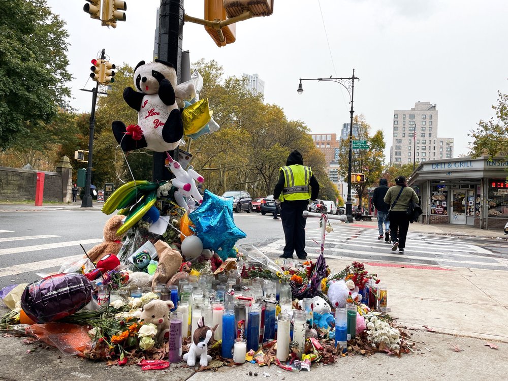 Flowers, stuffed animals and photos cover a corner in Fort Greene, Brooklyn where a 7-year-old girl was killed by an NYPD tow truck.
