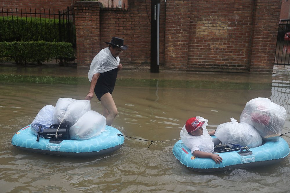 997c781e5gettyimages-839971222-jpg.jpeg People walk down a flooded street as they evacuate their homes after the area was inundated with flooding from Hurricane Harvey on August 27, 2017 in Houston<br>